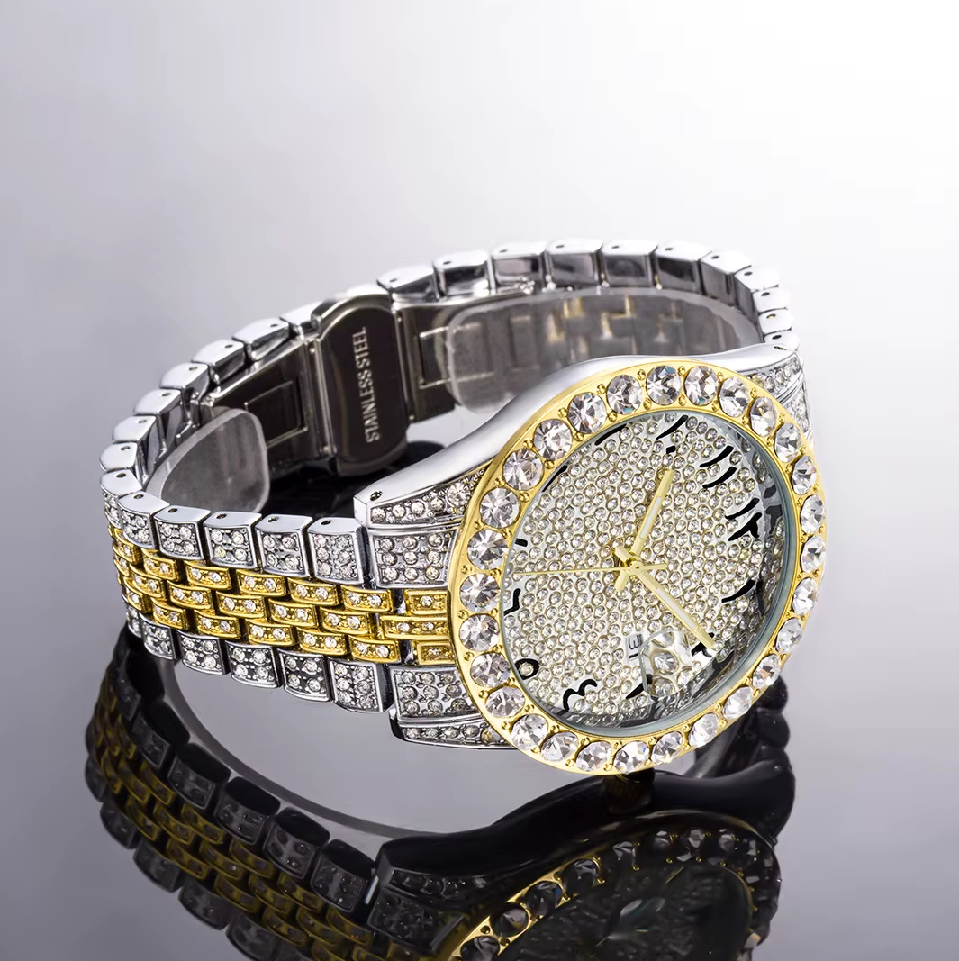 Luxury watch with a silver and gold band and diamond-studded face on a reflective surface.